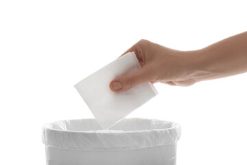 Woman putting paper tissue into trash bin on white background, closeup