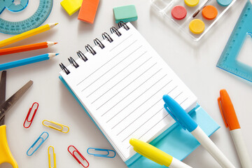 Children education. Accessories, school supplies, colored pencils and a drawing pad of Trendy colors   on white background . The concept of school children's creativity and "Back to school" concept.