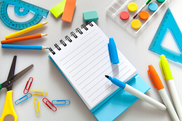 Children education. Accessories, school supplies, colored pencils and a drawing pad of Trendy colors   on white background . The concept of school children's creativity and 