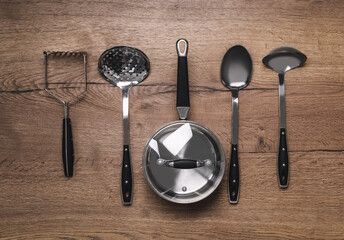 Set of cooking utensils on wooden table, flat lay