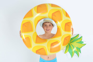 Cute little child in beachwear with bright inflatable ring on white background