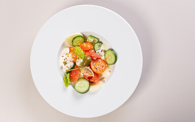 Quick and healthy food recipes. Salad with salmon, vegetables, herbs and capers on white plate. Mediterranean dish recipes. Top view. Copy space