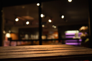 dark blurred background with empty table top, cafe restaurants windows..