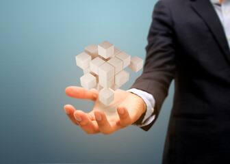 Hand holding wooden block.  risk and business strategy concept