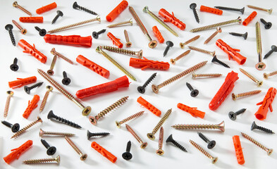 Placer different screws on white background. Different size screws, dowels. The concept of building...
