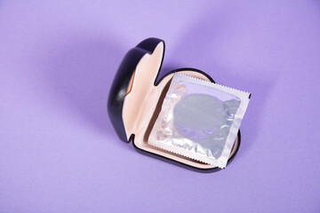 condom is in a black heart-shaped box, top view 