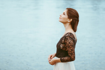 beautiful girl in a dress by the river