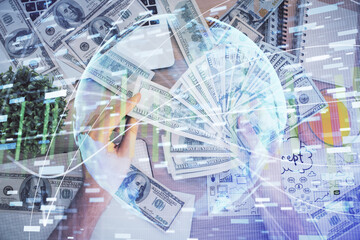 Multi exposure of financial theme drawing hologram and USA dollars bills and man hands. Business concept.
