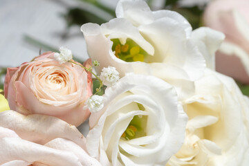 flower composition of light roses and eustoma close up. wedding day greeting card.