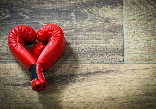 Gym background and fitness equipment and valentine concept. Boxing glove in shape of heart.