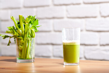 Healthy Celery diet for the treatment of incurable mysterious diseases. Fresh celery juice squeezed out on a juicer.drink, vegetable juice, studio shot