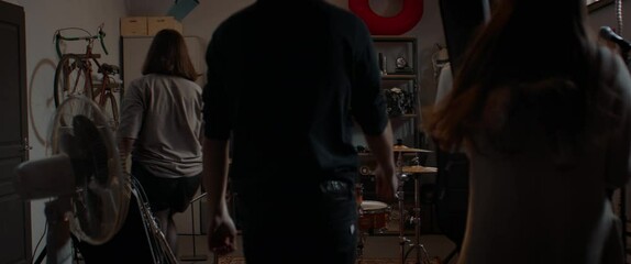 WIDE Members of teen music band walking into garage, getting ready for rehearsal. Shot with 2x anamorphic lens