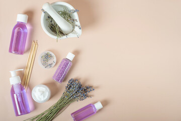 set of cosmetics with lavender on a beige background