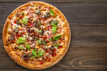 Fresh pizza with tomato sauce, black olives, mozzarella cheese, ham on wooden table closeup. Space for text or copy space. Pizza menu. Restaurant menu advertise