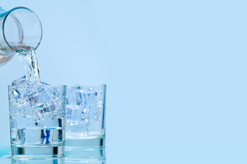 Pouring water. pouring drinking water from a glass decanter to glass.