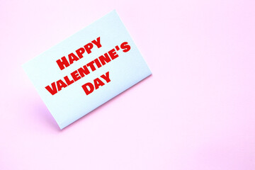 White paper card with the inscription Happy Valentine's Day on a pink background. Lesbian wedding