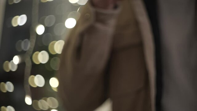 Cinematic close up shot with nice bokeh of a hipster man drinking a Lungo Coffee in a glass cup