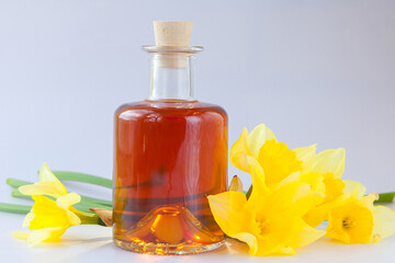 Essence of flowers  on white in beautiful glass jar