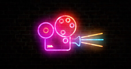 Cinema projector and camera symbol neon on brick wall