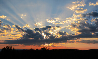 Celestial landscape with diffraction of the sun's rays during sunrise.