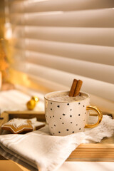 Composition with cup of hot drink on windowsill