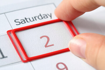 Woman moving date slider on calendar onto February 2nd, closeup. Groundhog day