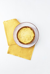 Tofu cake on a yellow napkin. Sugar, gluten and lactose free. Vertical orientation, top view.
