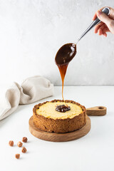Tofu cake with salted caramel on a wooden board. Sugar, gluten and lactose free.