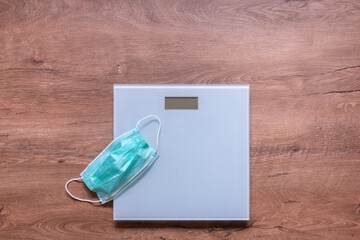 Electronic weight scale and medical mask on it