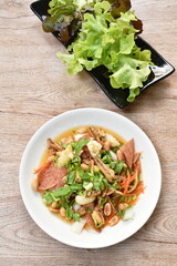 crispy fish with pork couple maw topping peanut in spicy and sour chili sauce salad on plate