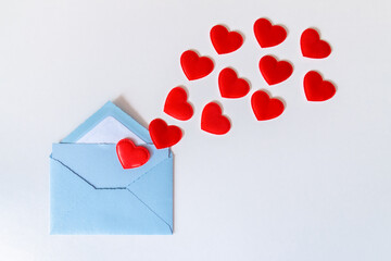 Blue envelope and flying red hearts, love letter