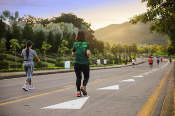 Obraz premium Woman exercise walking in the park in autumn morning.