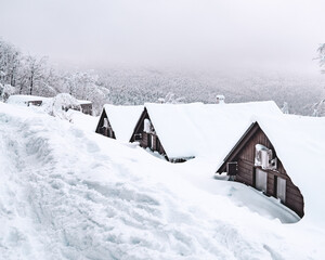 Fototapeta na wymiar snow covered house in the mountains
