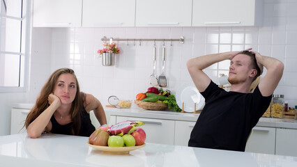 Portrait of couple using laptop in the kitchen