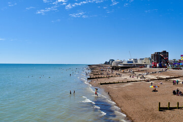 People swimming in the sea and enjoying summer in Worthing, UK