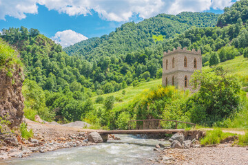 Beautiful mountain scenery. Mountains covered with green trees with residential settlements. In...