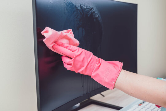 Home sanitizing, cleaning. Disinfectant spray bottle for disinfecting. COVID-19 prevention sanitizing inside. Hand holding sanitizing spray.