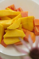 Close-up of mango and papaya fruit slice on the table. Colorful slice of fruits on the table.