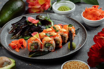 Fototapeta na wymiar Sushi Roll with salmon tuna avocado royal prawn cream cheese Philadelphia caviar tobica chuka. Sushi menu. Japanese food