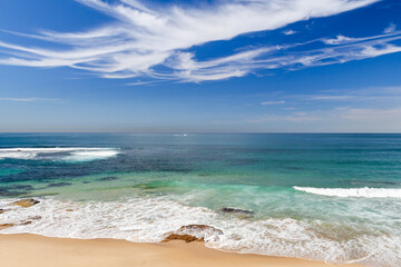 White Clouds at Cronulla Beach, New South Wales, Sydney, Australia. Sunny Bright day vibrat blue colors

