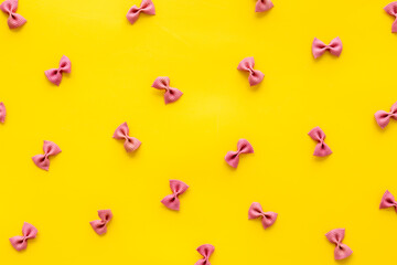 Italian colorful pasta pattern, top view. Various vegan farfalle pasta