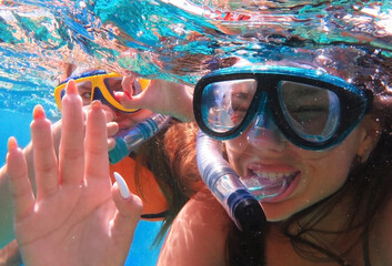 Underwater shot. Cute teenage girl diving with scuba in a tropical sea. Travel lifestyle, outdoor...