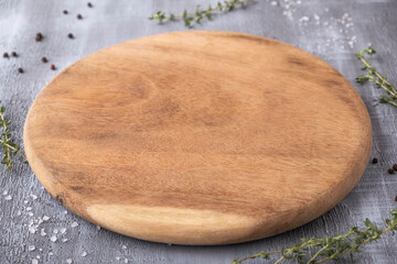 Empty round wooden board with spices.
