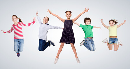 Cheerful Boys And Girls Jumping On Gray Studio Background, Collage