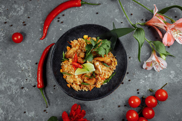 Thai rice with chicken. Thai dish of rice, chicken, Yalta onion, corn, pineapple, tomato, soy sauce, chili paste, cilantro, lime, chili pepper