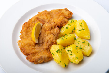 Pork chop with parsley potatoes and lemon