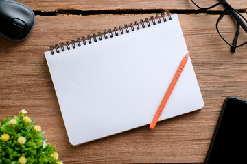 Top view of wooden table and stationery with copy space, flat lay.