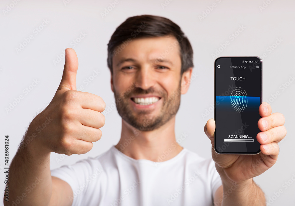 Poster man showing phone with fingerprint scanner gesturing thumbs-up, white background