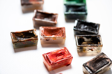 Top view of Work Process Blank Watercolor Paper pad, Watercolor Painting Supplies, Brushes and Colorful Pencil. Creation process of watercolor painting. Copy space.