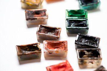 Set of watercolor paints and paintbrushes for painting closeup. Selective focus.